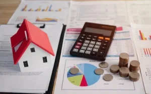 A model house, financial documents, money, and a calculator represent the Nevada homestead exemption in bankruptcy proceedings.